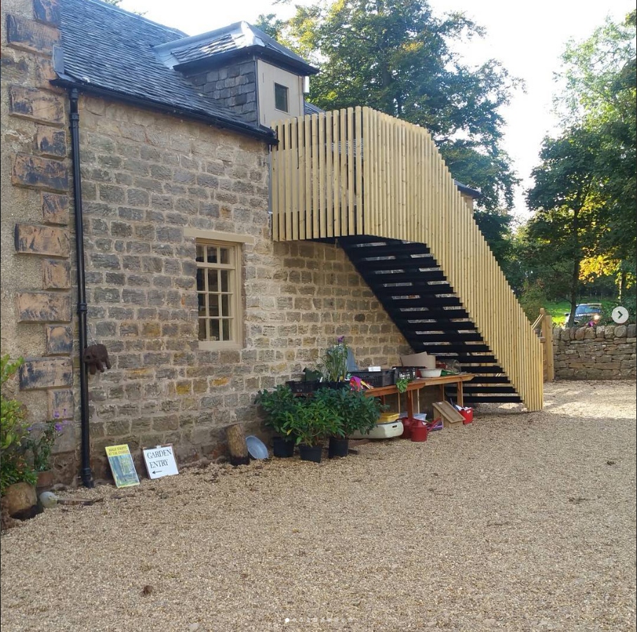 Bespoke handcrafted external wooden staircase on a stone wall building